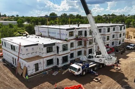 Aerial view of modular buildings with a crane on site